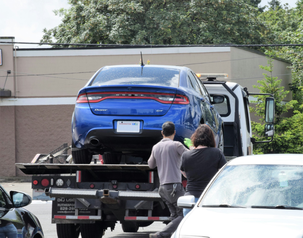 Tow truck transporting a broken-down vehicle in Norfolk, VA.